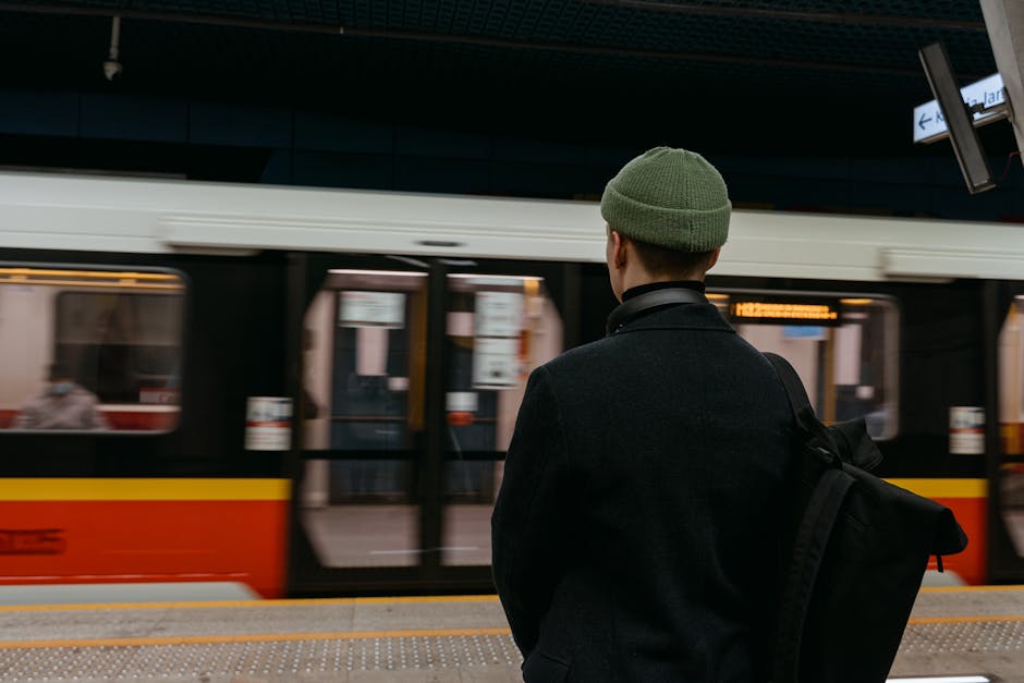 backpacker waiting at german train station platform