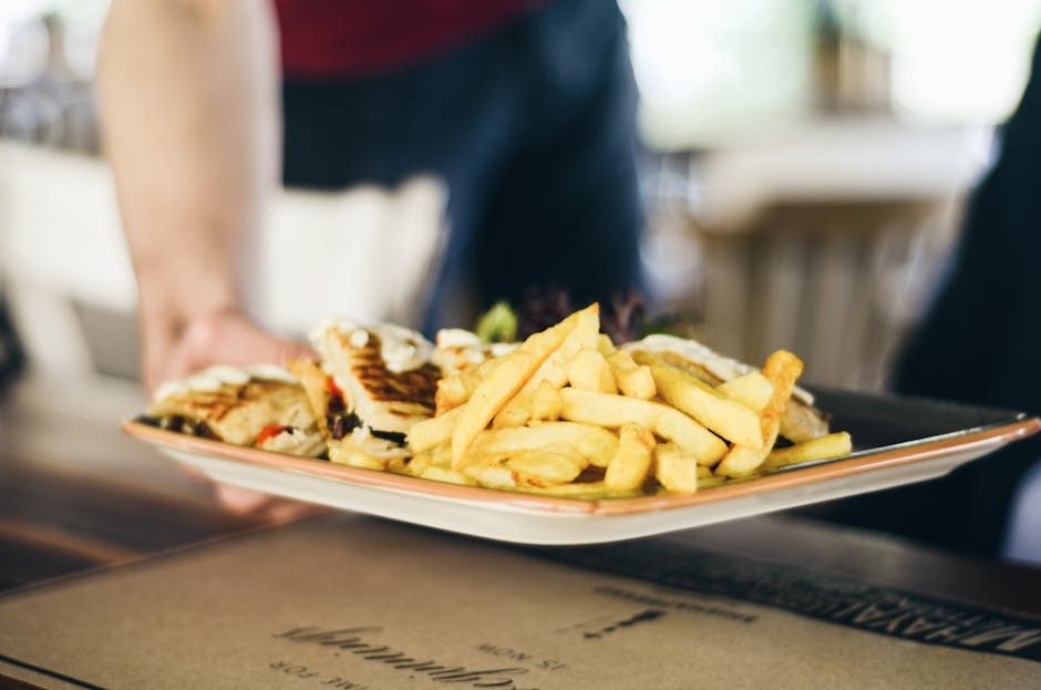 Brazilian restaurant worker serving lunch tray