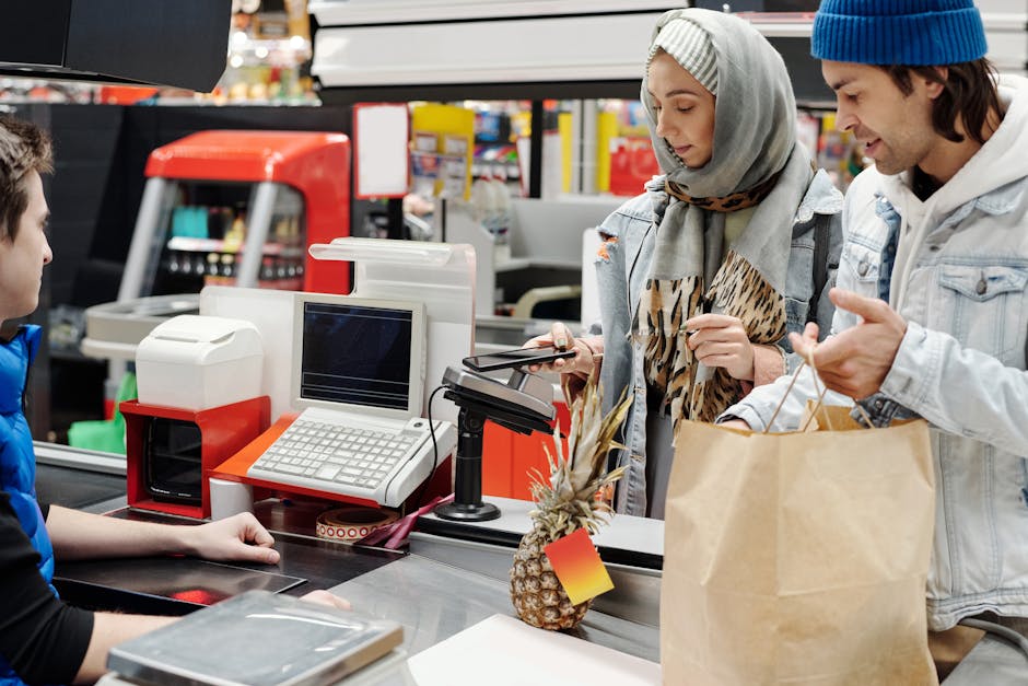 Brazilian store cashier showing QR code payment to customer