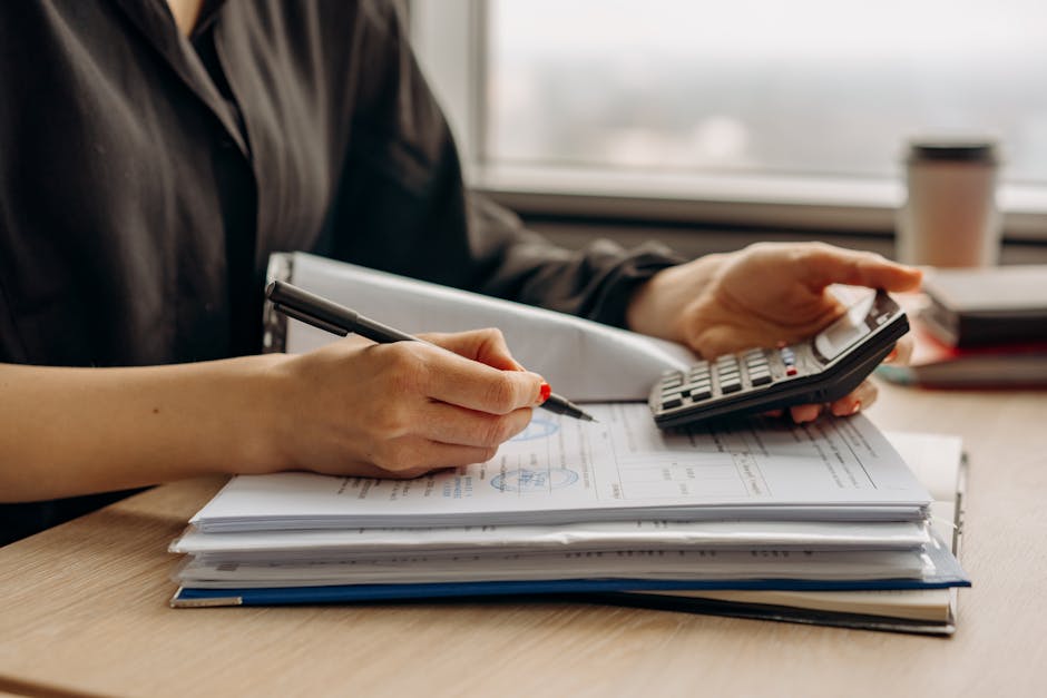 business documents and calculator on desk