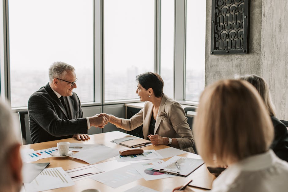business handshake meeting in conference room
