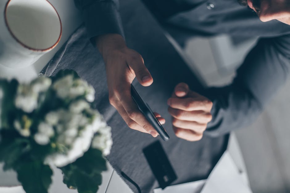 business owner using smartphone banking app