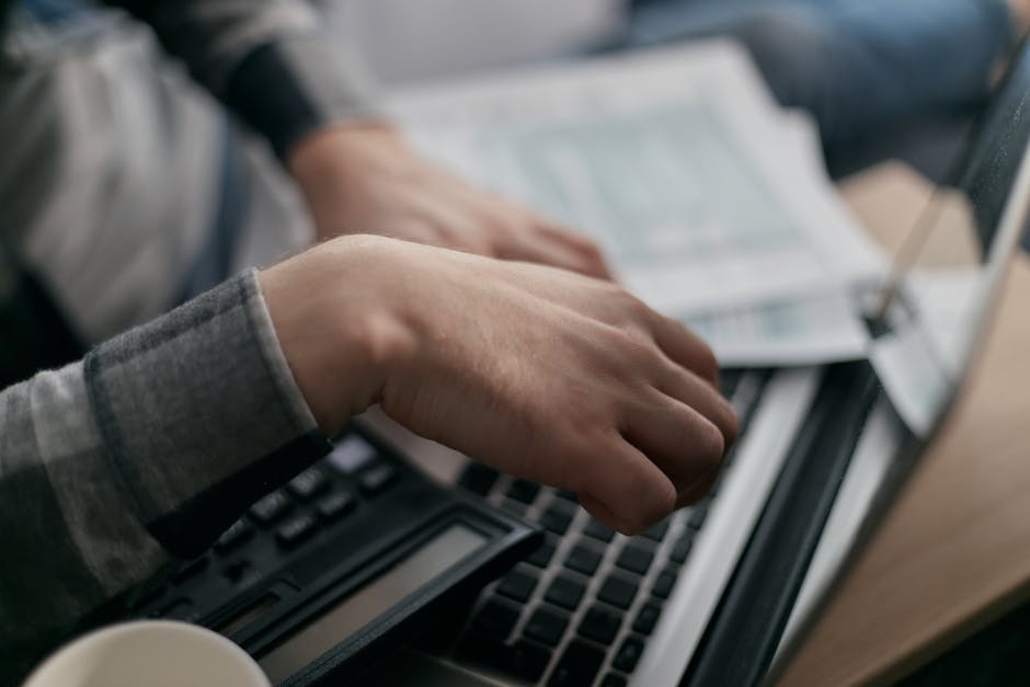 business person issuing electronic invoice on laptop