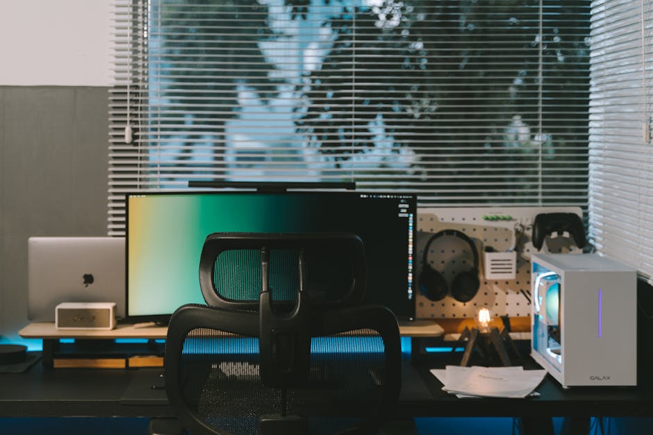 clean desk setup with computer and papers near window