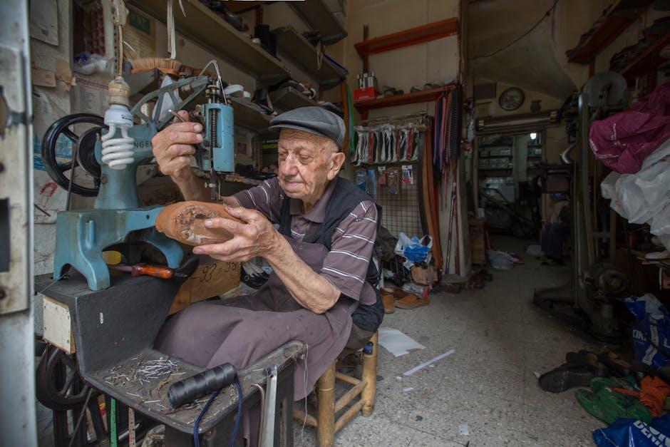 cobbler working in small traditional workshop