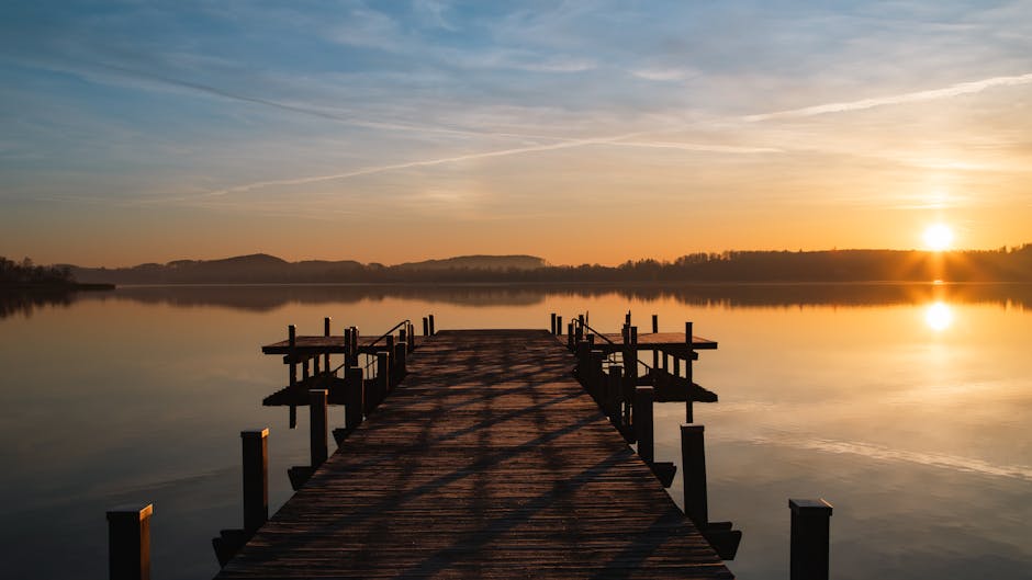 colorful wooden pier at Masurian lake sunrise