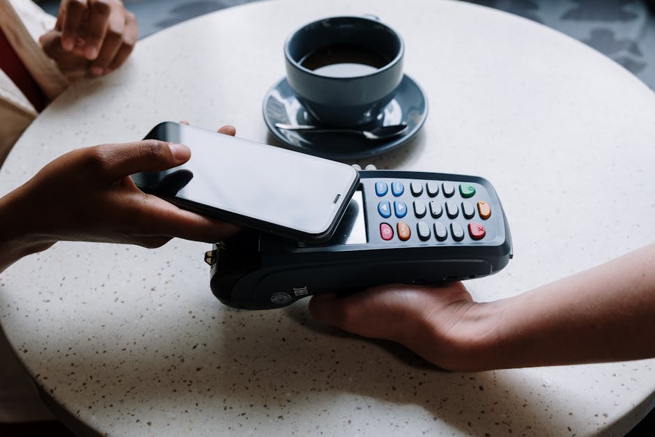 couple paying at coffee shop with phone in Brazil