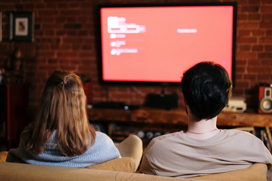 family watching movies on big screen TV at home
