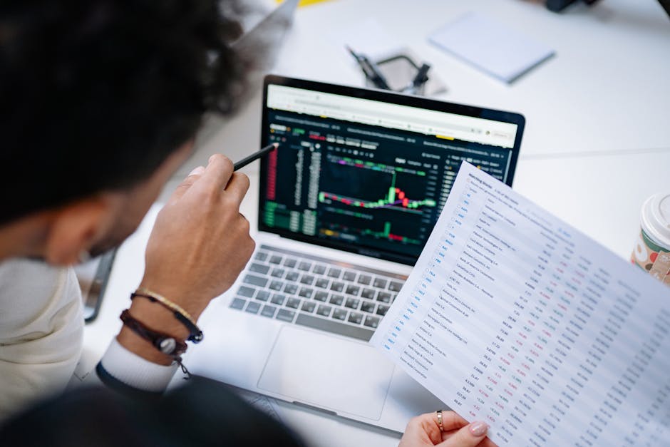 French business professional using laptop with growth metrics