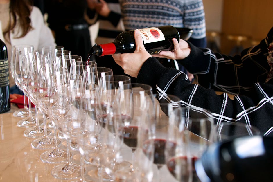 French sommelier pouring red wine
