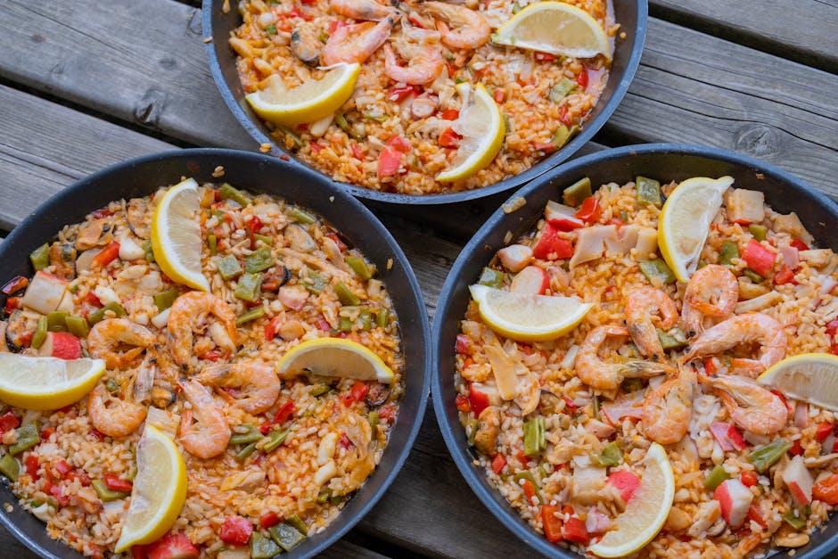 fresh ingredients for paella on wooden table