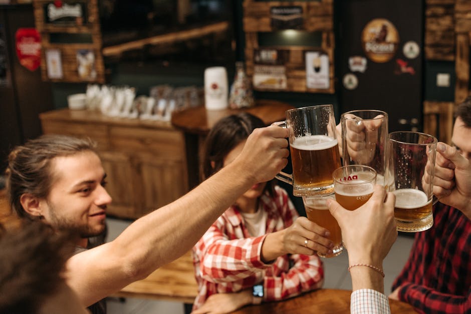 friends toasting with craft beer glasses indoors