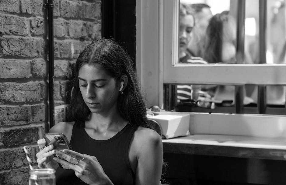 Friends using smartphones at a Parisian cafe