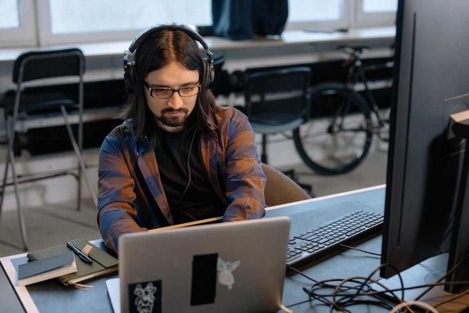 German developer at modern office working on laptop
