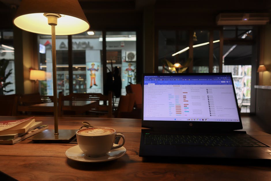 laptop open on wooden cafe table