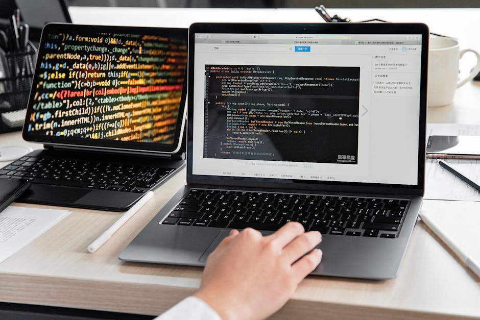 laptop with code on screen in modern office