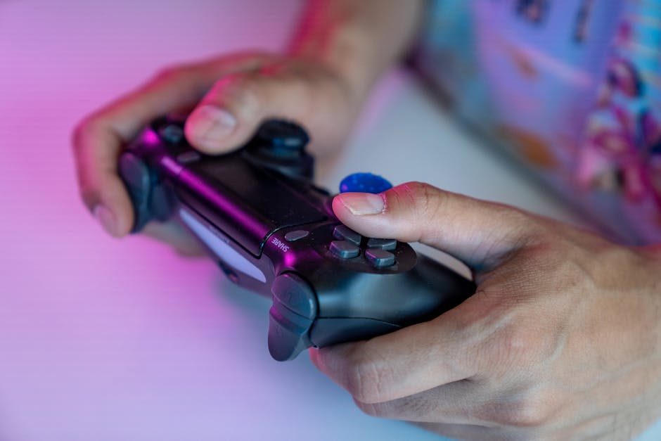 man holding gaming console controller close up