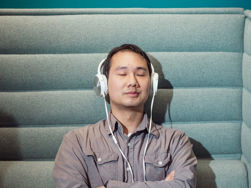 man listening to music with in-ear headphones