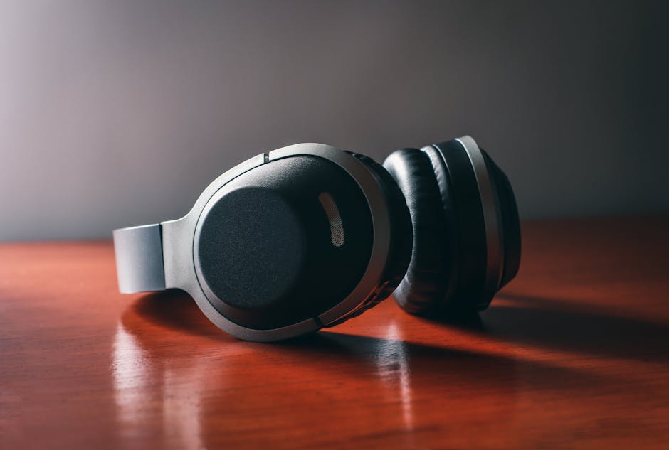 modern headphones with noise cancellation on wooden desk