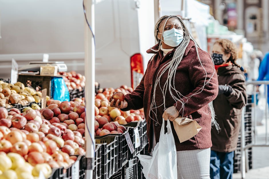 person browsing fresh produce at outdoor market