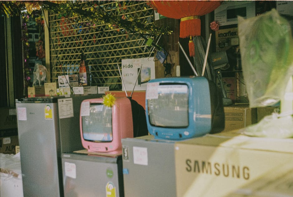 person comparing television models in electronics store