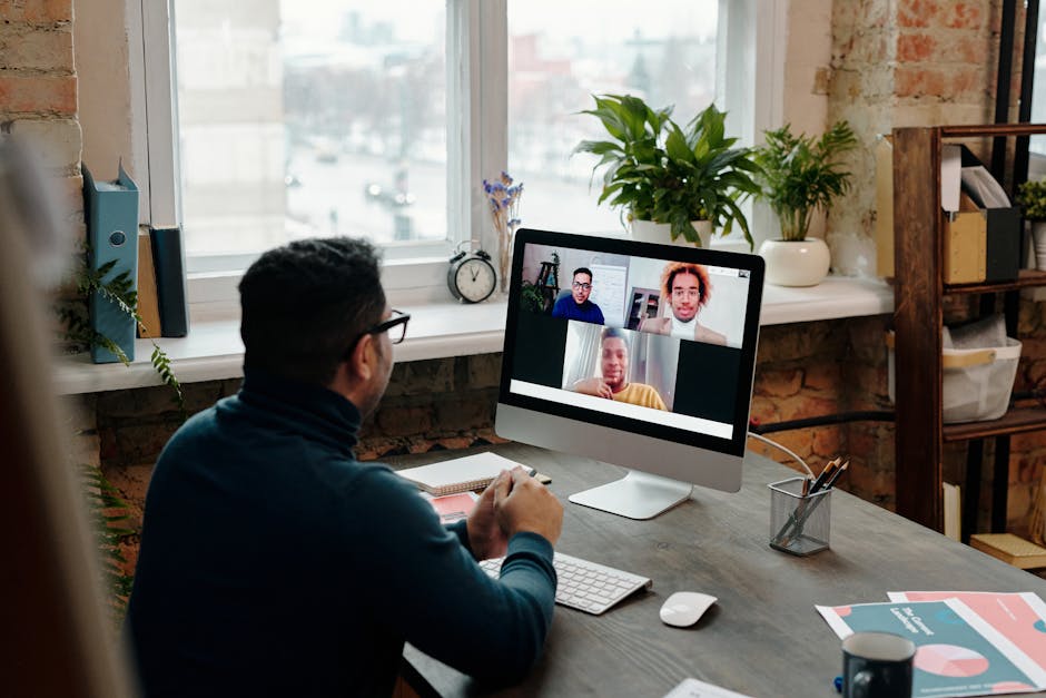 person conducting video call at modern home office