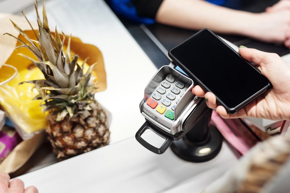 Person paying with phone at a French market
