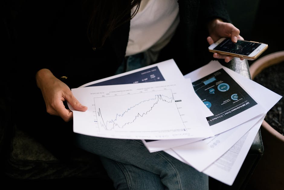 Person reading financial chart on smartphone