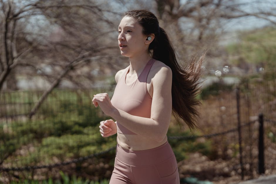 person running with earbuds in park
