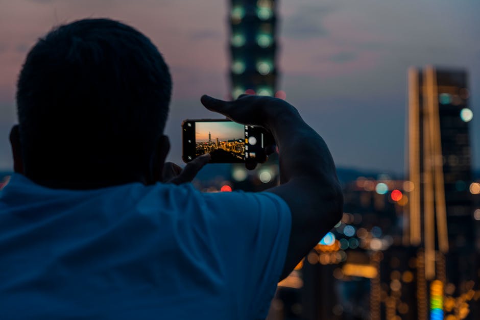 person taking photo with smartphone city Barcelona