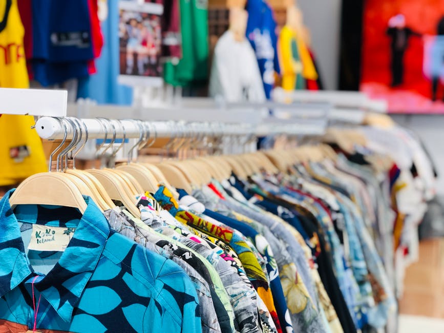 pile of colorful vintage shirts and dresses on display