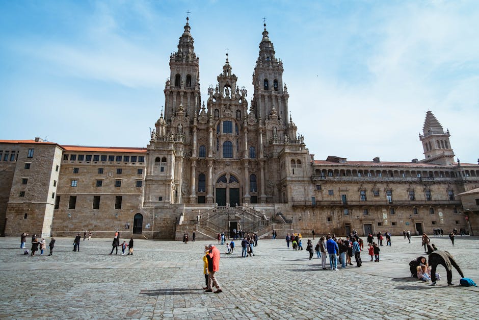 pilgrim standing before Santiago de Compostela cathedral at dusk