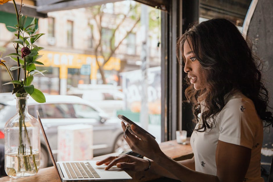 Polish business owner reviewing IT costs on laptop at coffee shop