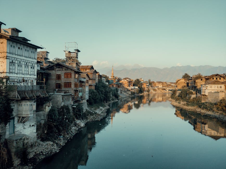 quiet riverside town with old buildings at sunset