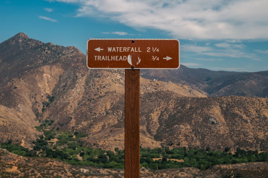 red wooden hiking signs at mountain trail junction