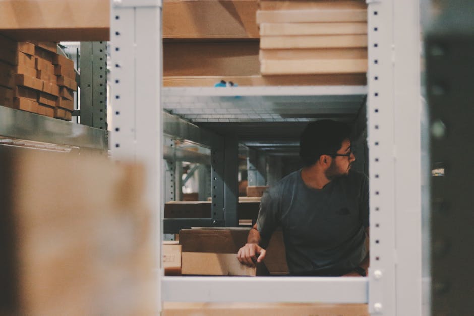 refurbished laptops arranged on warehouse shelves