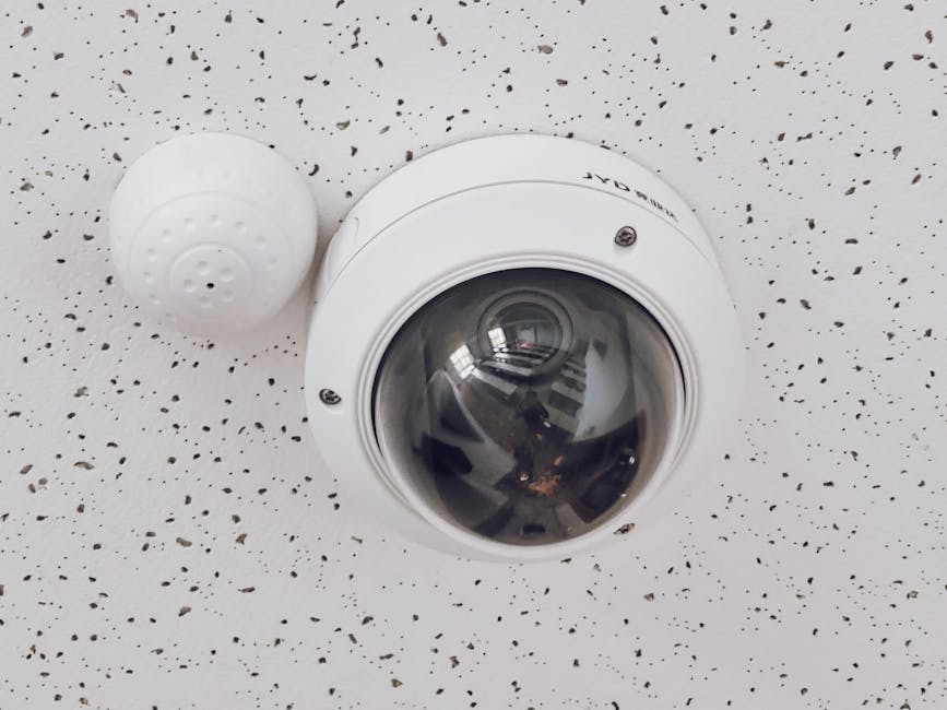 security camera installed on white wall indoors