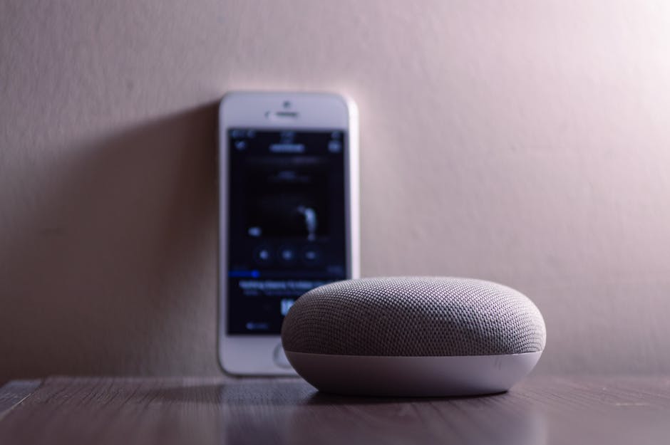 smart home device on wooden table with phone