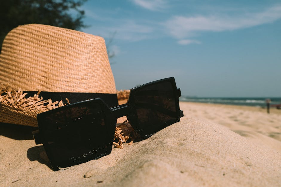 Stylish beach accessories on sand tropical setting