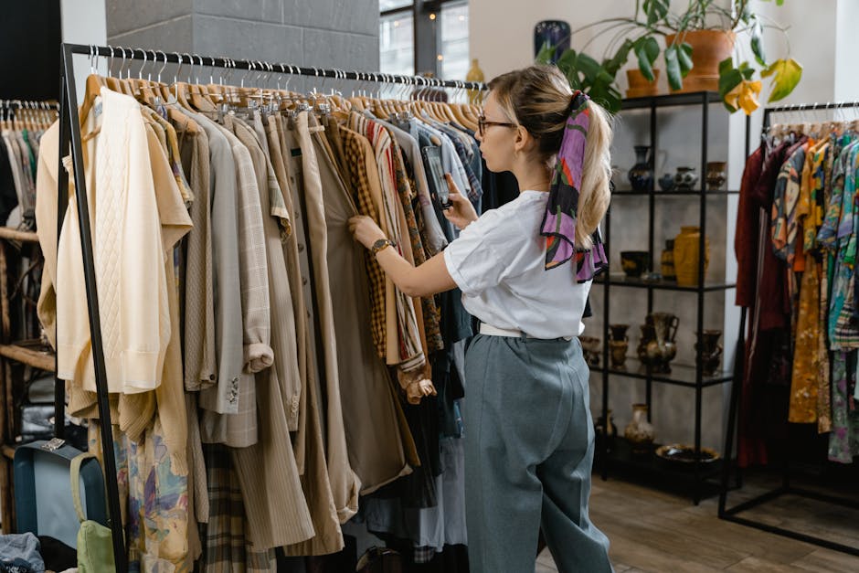 Stylish woman browsing clothing rails in store
