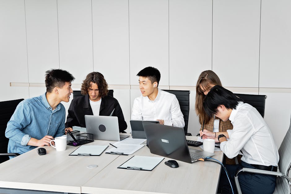 team meeting working on laptops