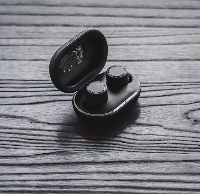 wireless earbuds on wooden desk