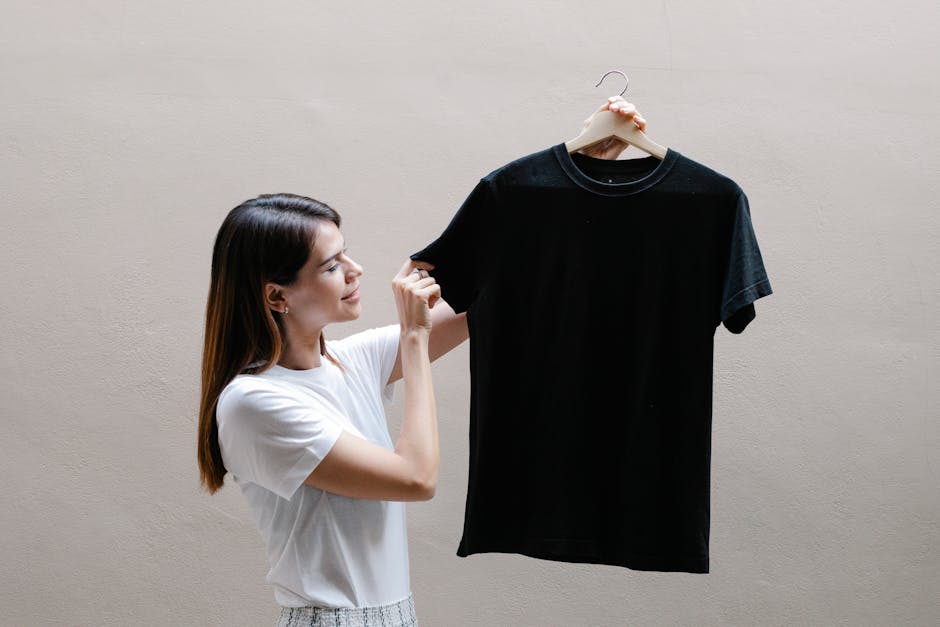 woman choosing organic cotton t-shirt at boutique