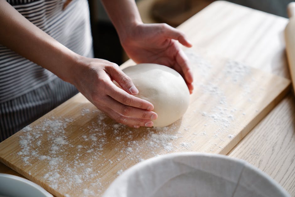 woman kneading dough at home kitchen counter
