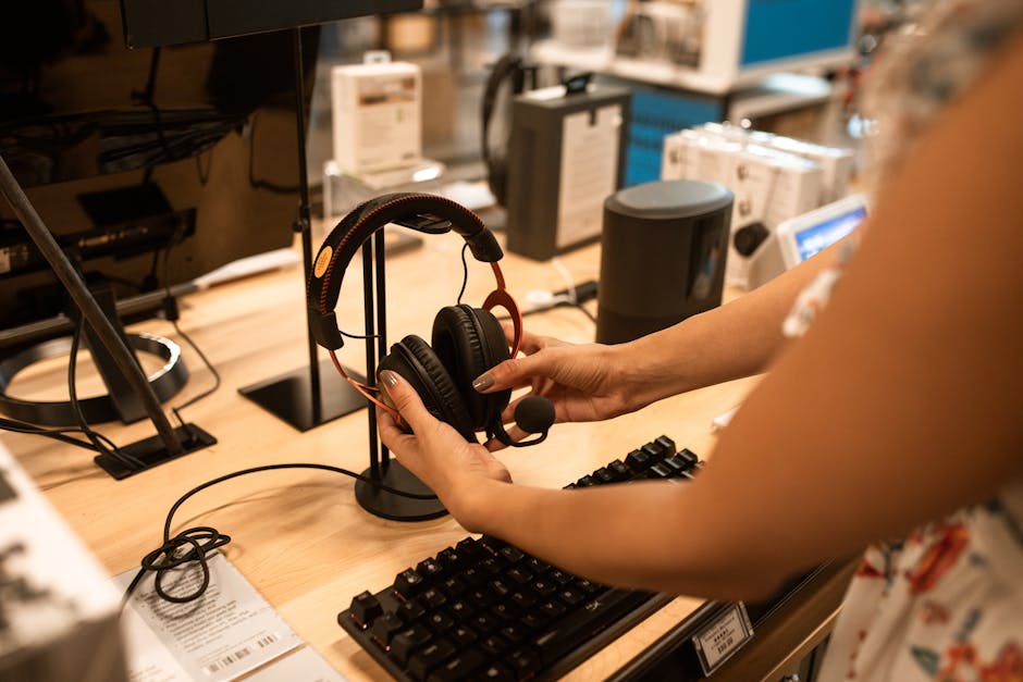 woman testing headphones in electronics store aisle