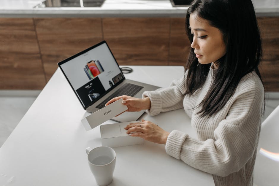 woman unboxing new tablet at home