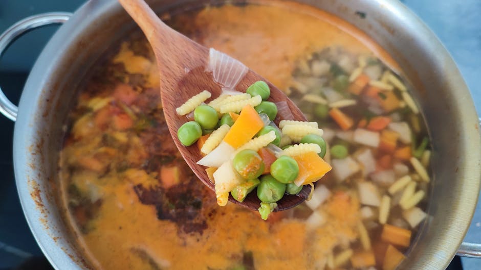 wooden spoon stirring traditional Polish soup pot