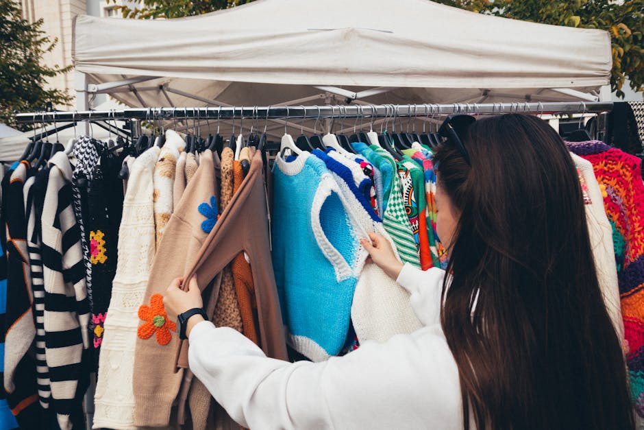 person browsing vintage clothes in urban market